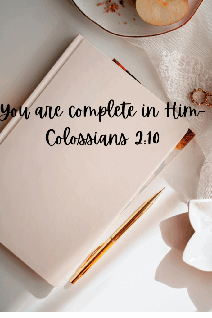 Bible open to Colossians 2:10 with journal and pen beside it, symbolizing wholeness in Christ and personal spiritual growth